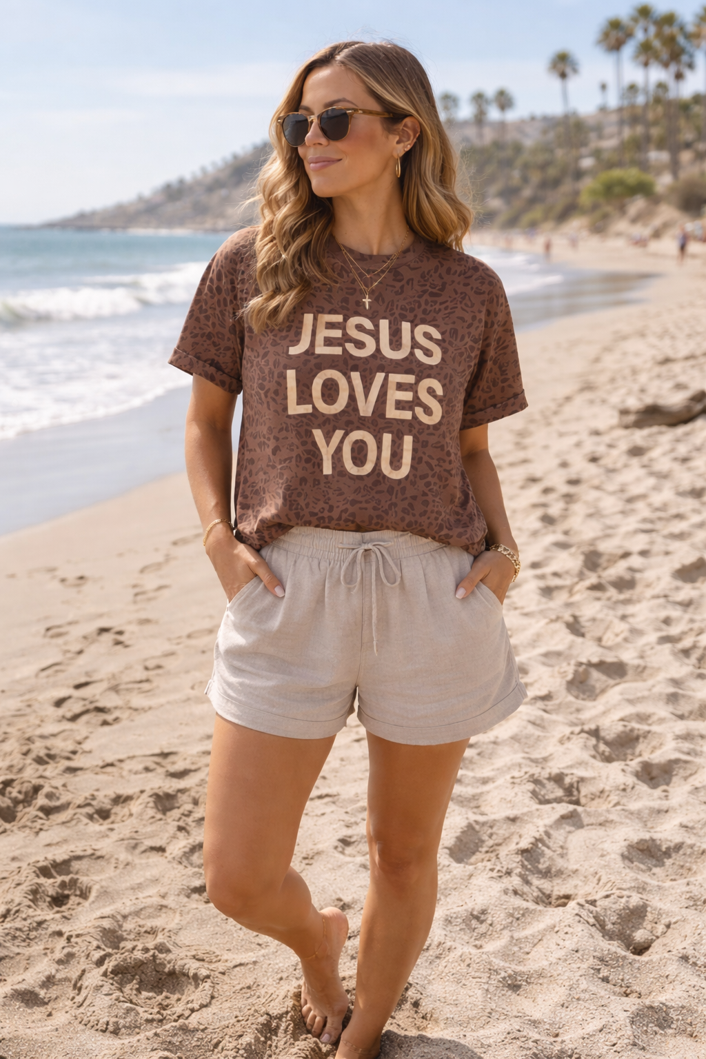 Woman wearing a 'Jesus Loves You' t-shirt on a beach