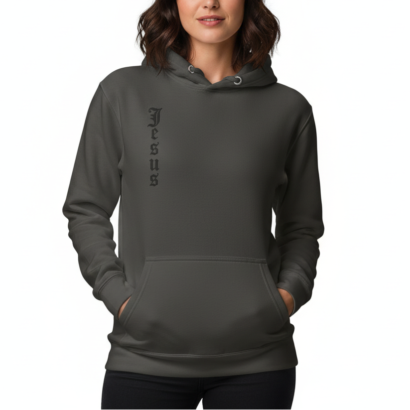 Woman wearing a dark gray hoodie with 'Jesus' printed on it against a white background