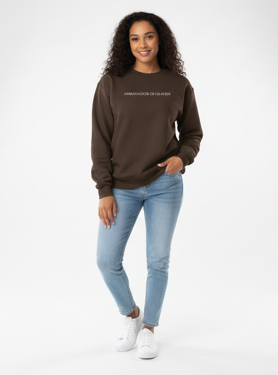 Woman wearing a brown sweatshirt and light blue jeans on a white background